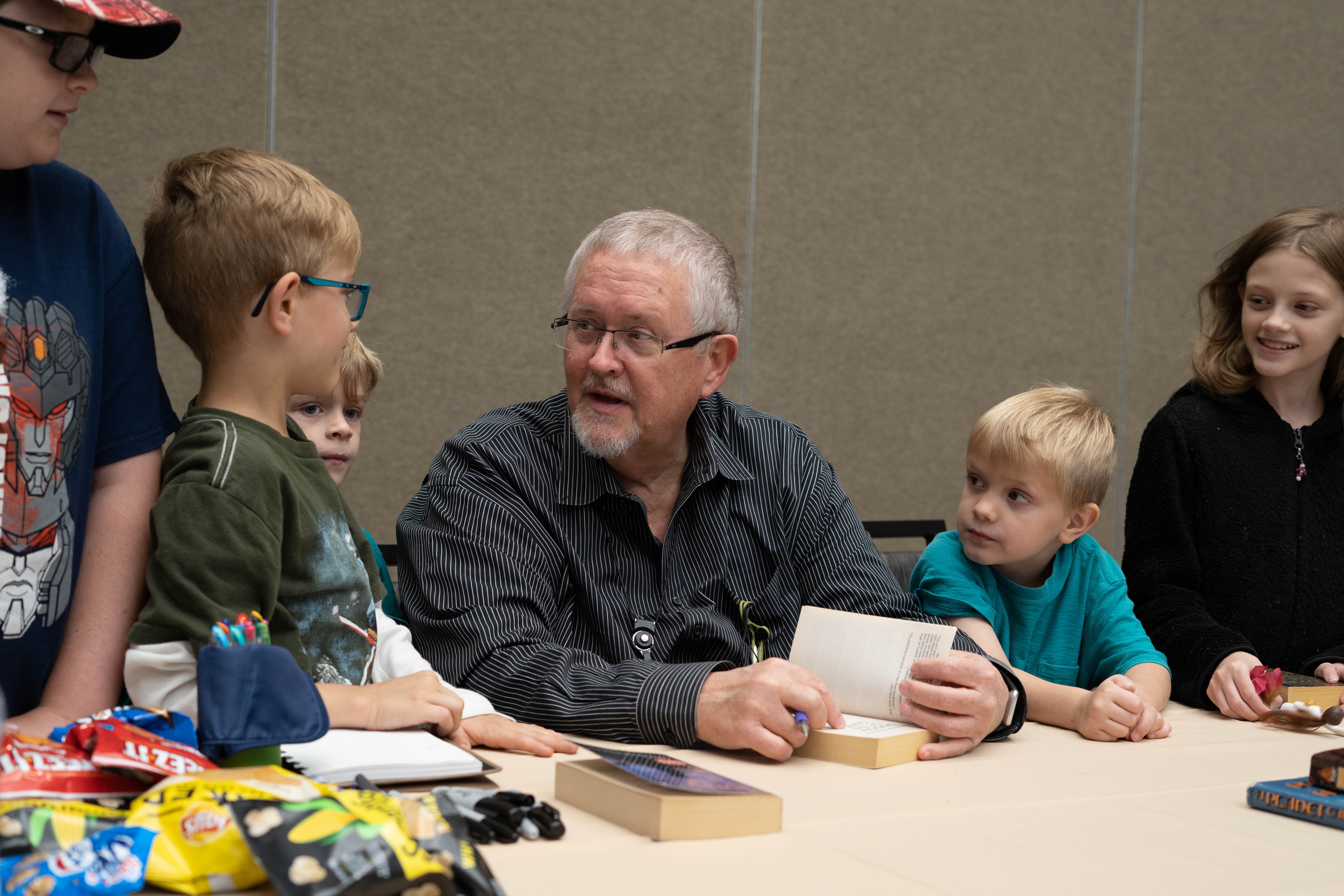 Orson Scott Card talking to children at book signing
