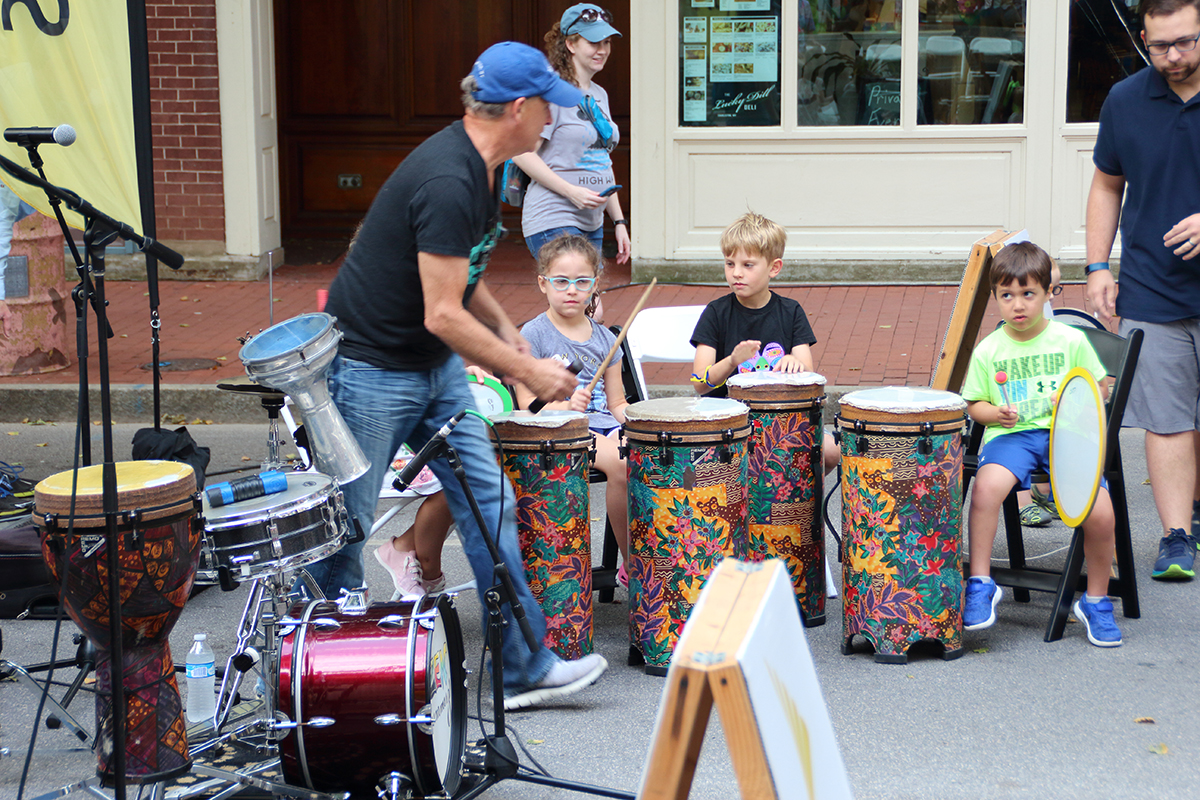 Musicians teach children drumming