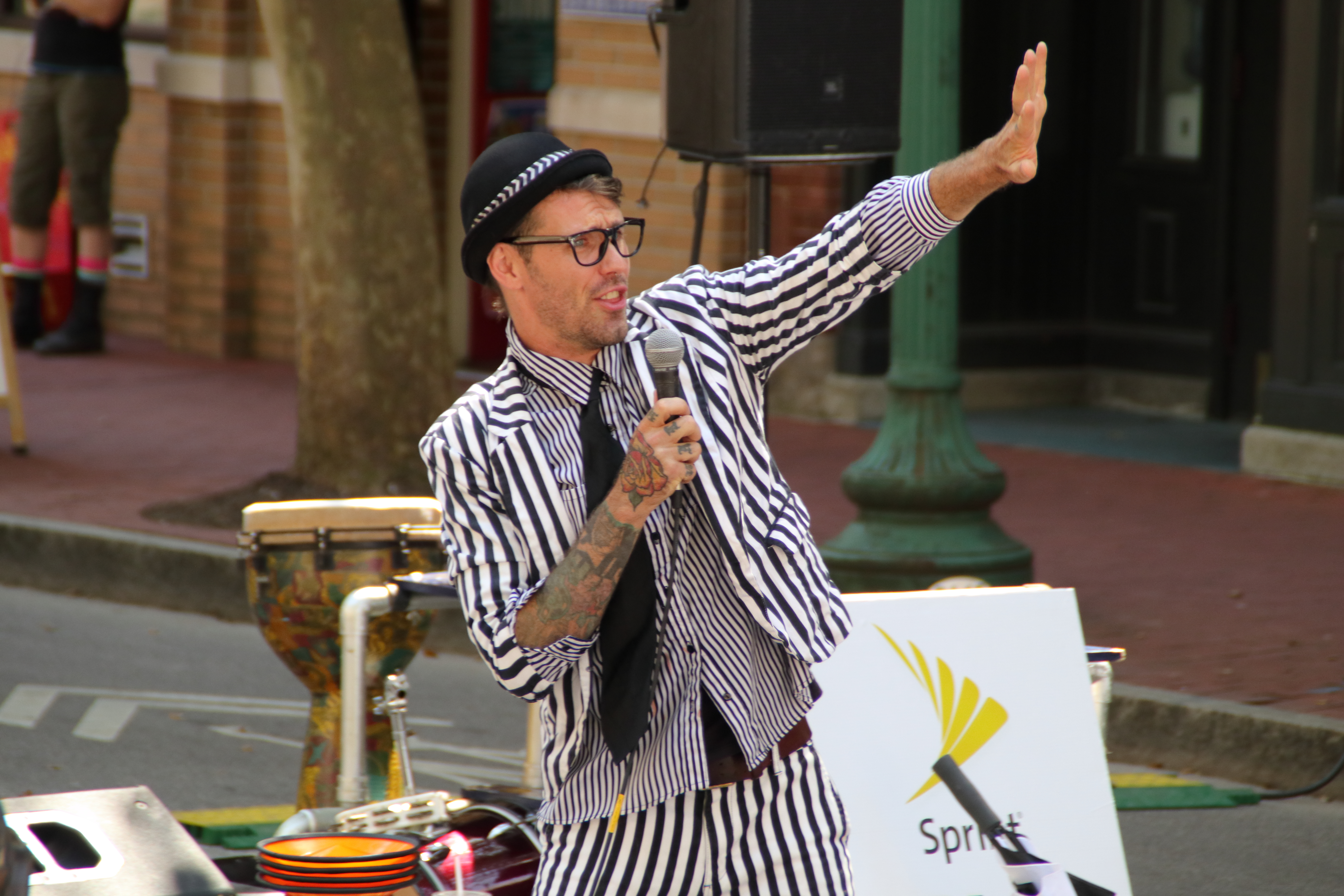 Magician in striped suit and bowler hat performing