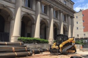 Machinery and building materials outside Main Library arches