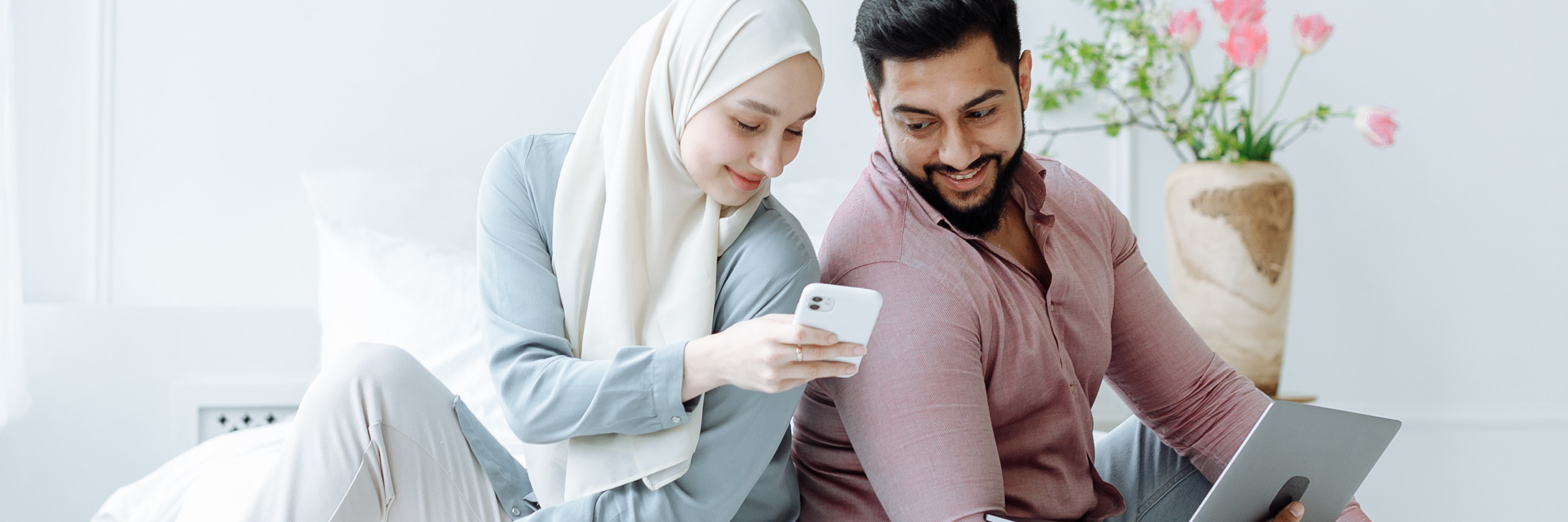 Couple looking at mobile phone together and smiling