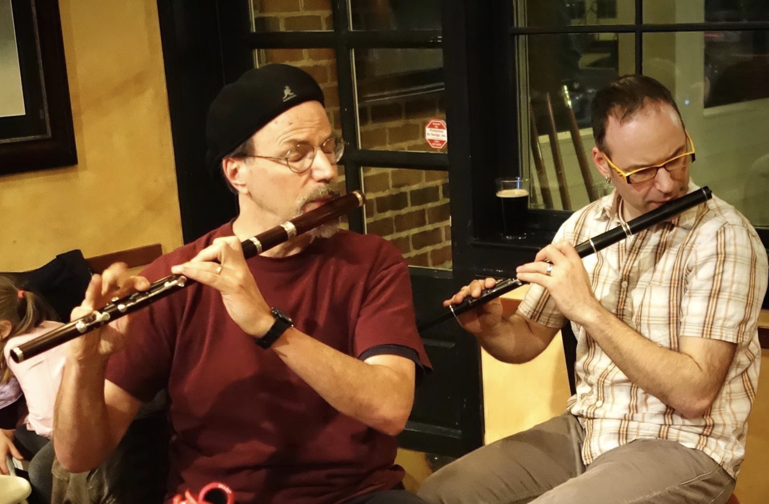 Patrick and Matthew Olwell play wooden flutes. 