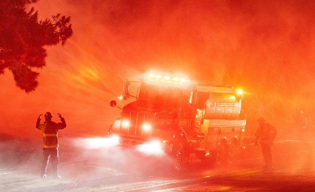 Firefighters work alongside a fire truck