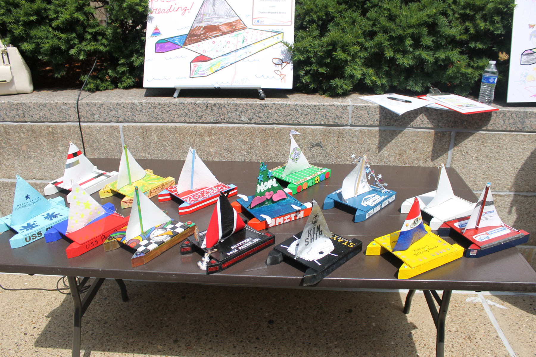 Various miniature boats sitting on a table.