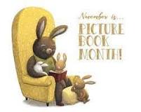 Rabbit sitting in a large chair reading a picture book to three smaller rabbits
