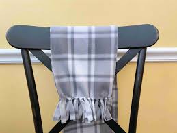Gray and white fleece scarf on a black chair