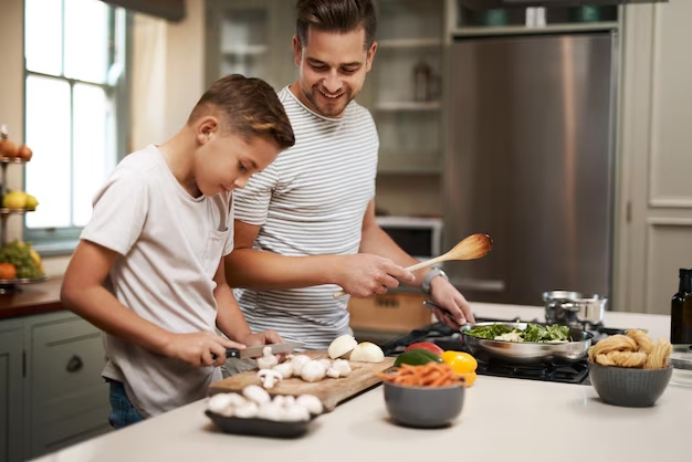 Father and son cooking together in family kitchen