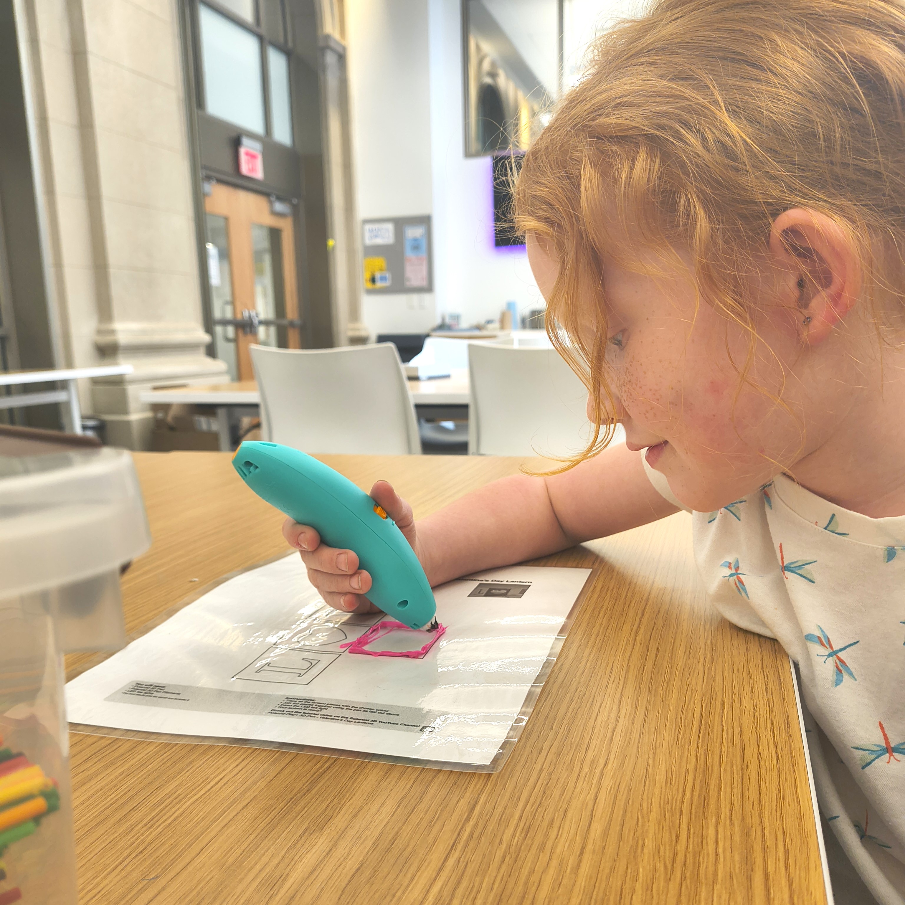 photograph of a young child using a 3D doodle pen