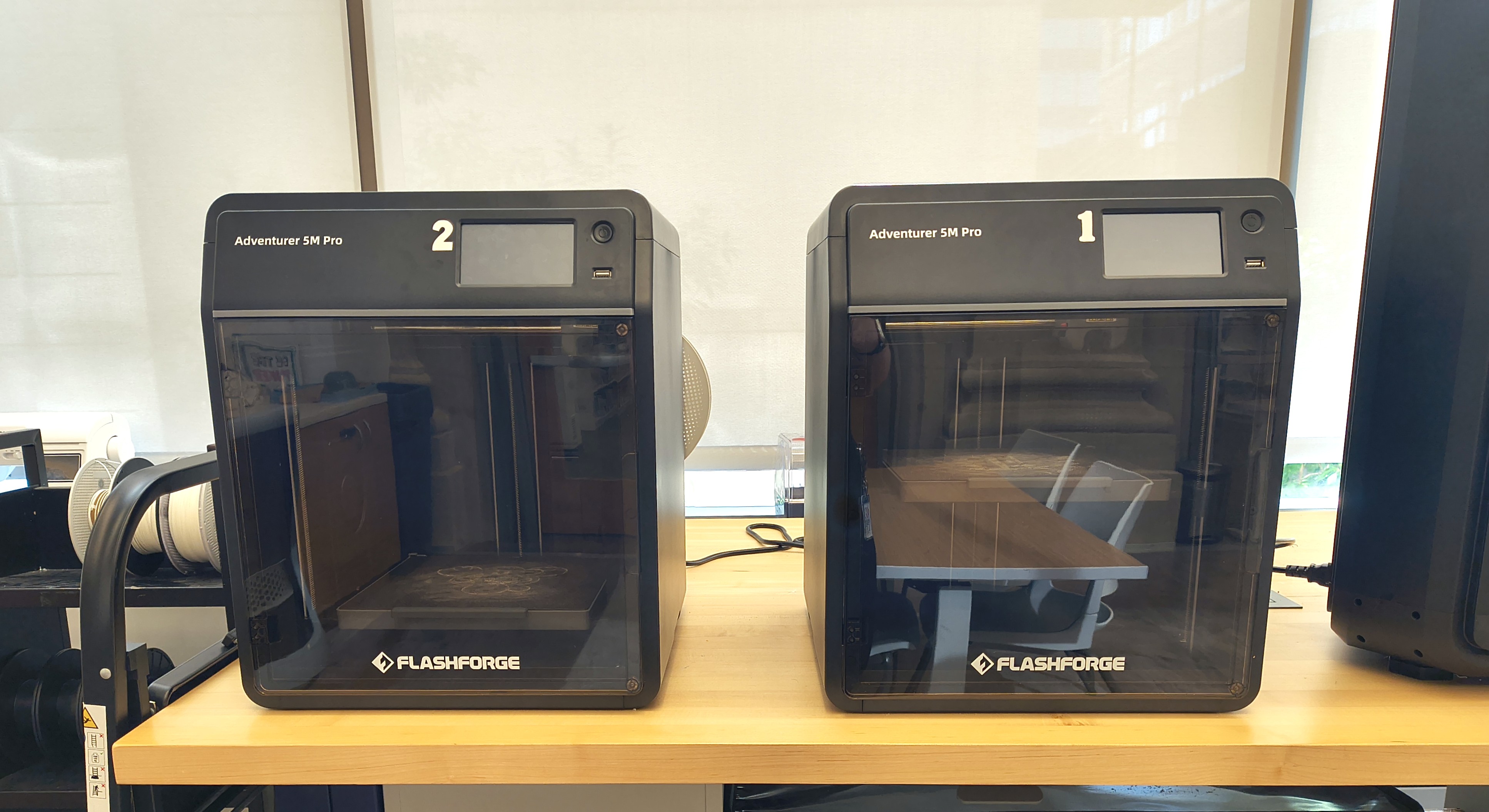 photograph of two Flashforge 3D printers