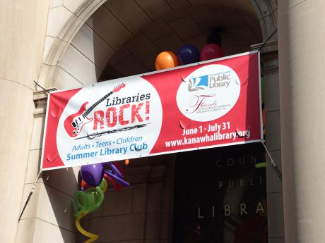 "Libraries Rock" banner in arch with balloons