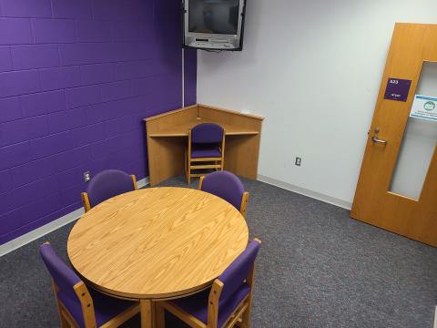 Riverside study room A23, complete with round table, chairs, CRT TV with DVD player, and small corner desk with chair