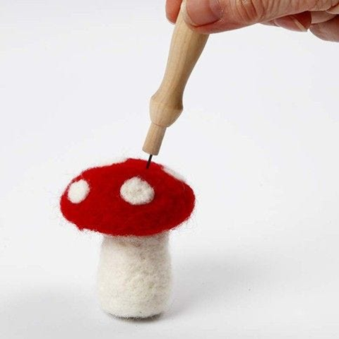 a person making a felted mushroom