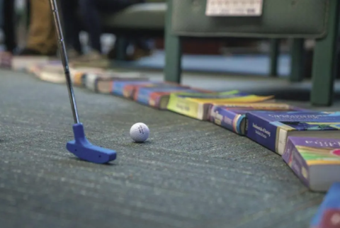 Mini golf club and books