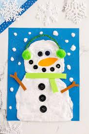 Puffy paint snowman; blue background; snowflakes; scarf; earmuffs