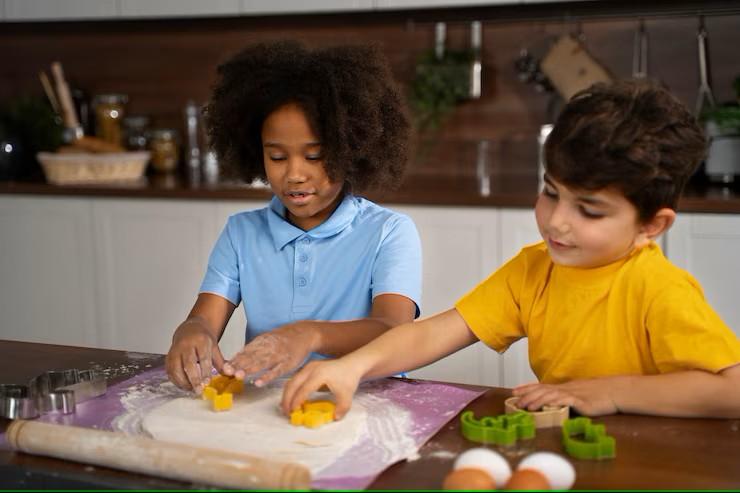 Two children in colorful clothes cooking together