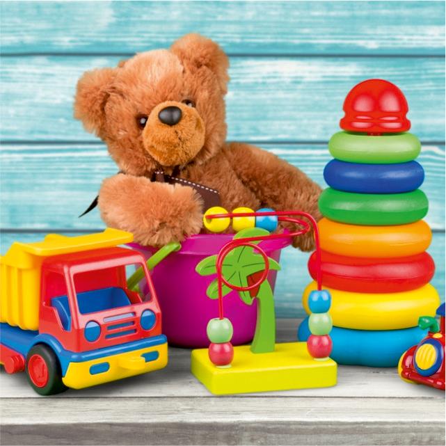 A teddy bear and colorful baby toys