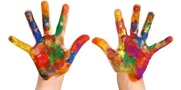 Little hands covered in colorful paint
