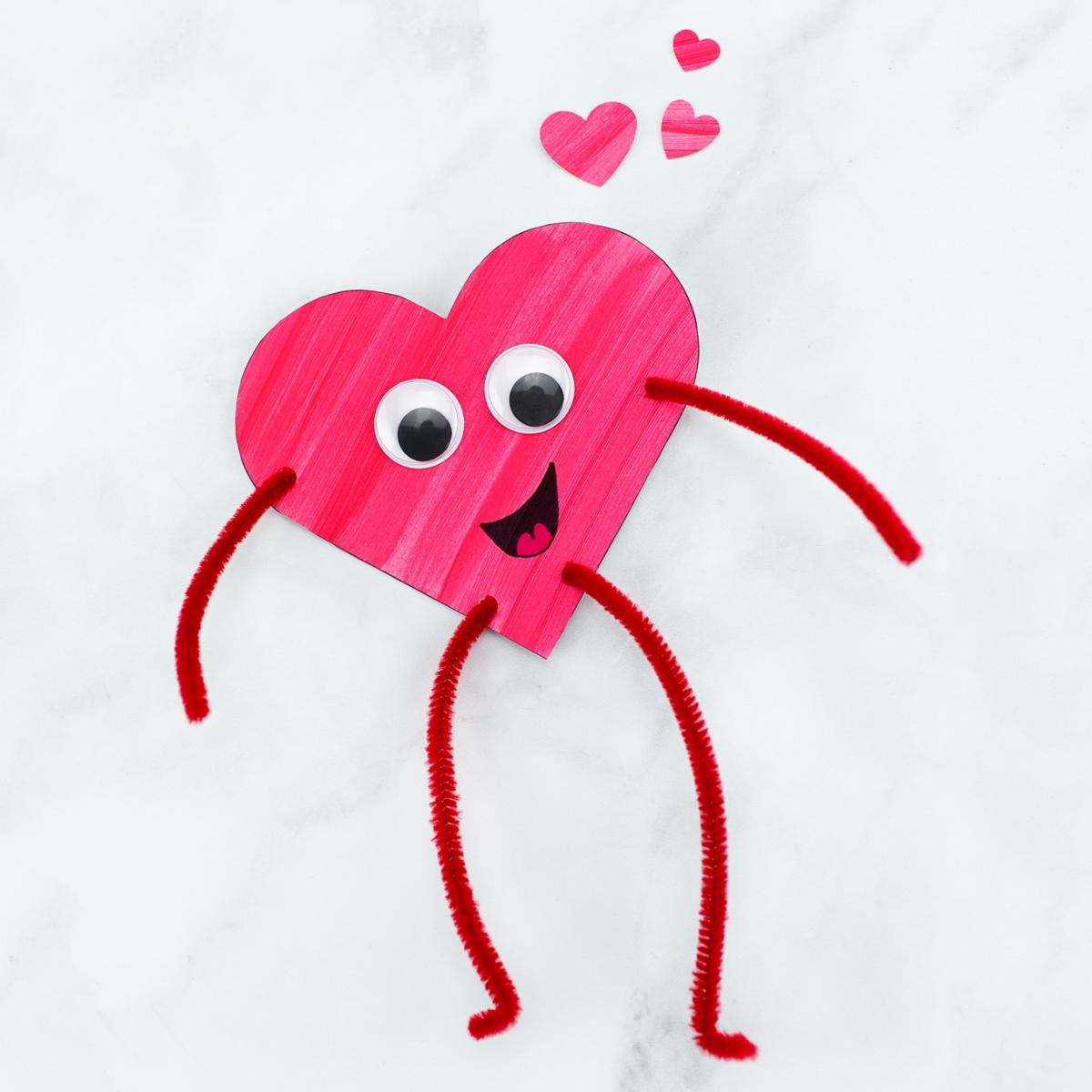 Red heart face with googly eyes, arms, & legs