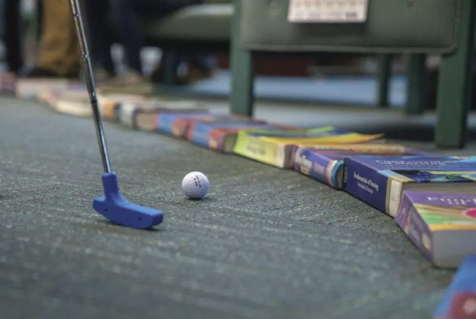 Mini golf club and books